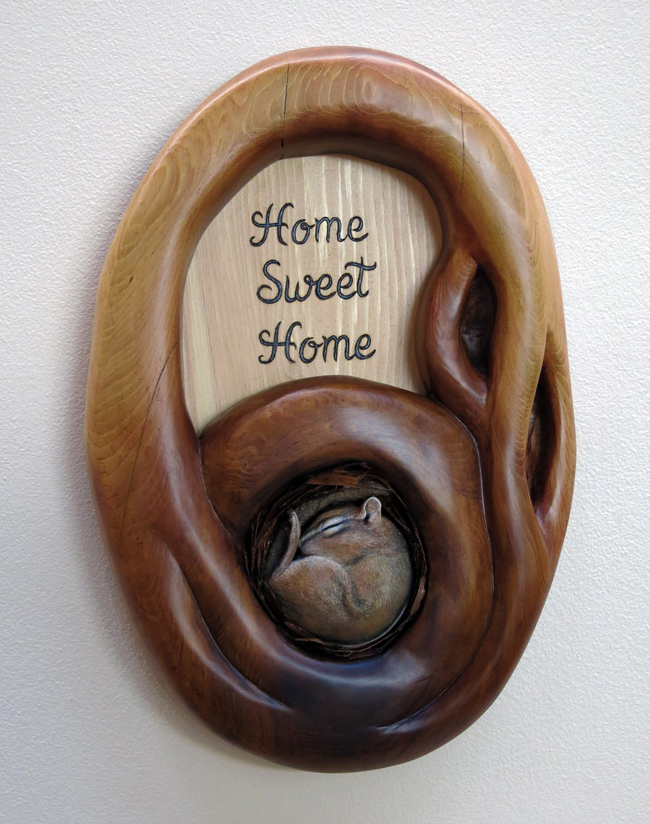 chipmunk curled up sleeping in cedar Home Sweet Home den